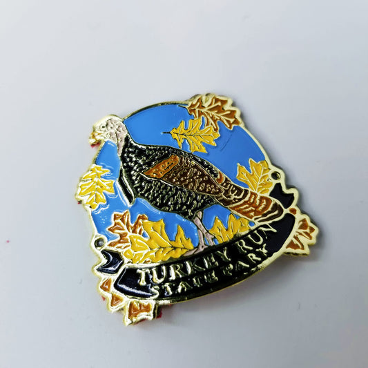 Hiking stick medallion with a turkey design and 'Turkey Run State Park' text on a blue background