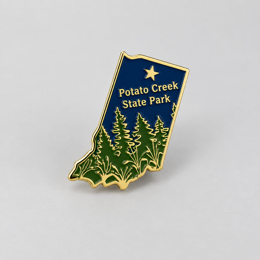 Potato Creek State Park enamel lapel pin shaped like Indiana with gold details and green forest design