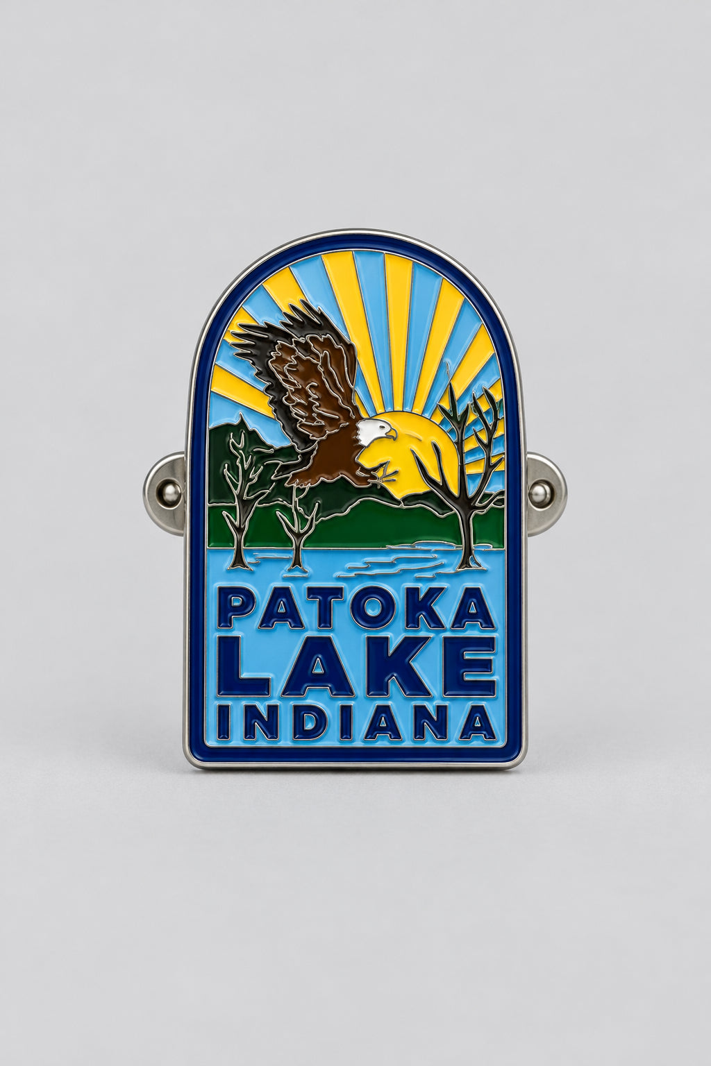hiking medallion featuring a bald eagle, sunset, and lake view
