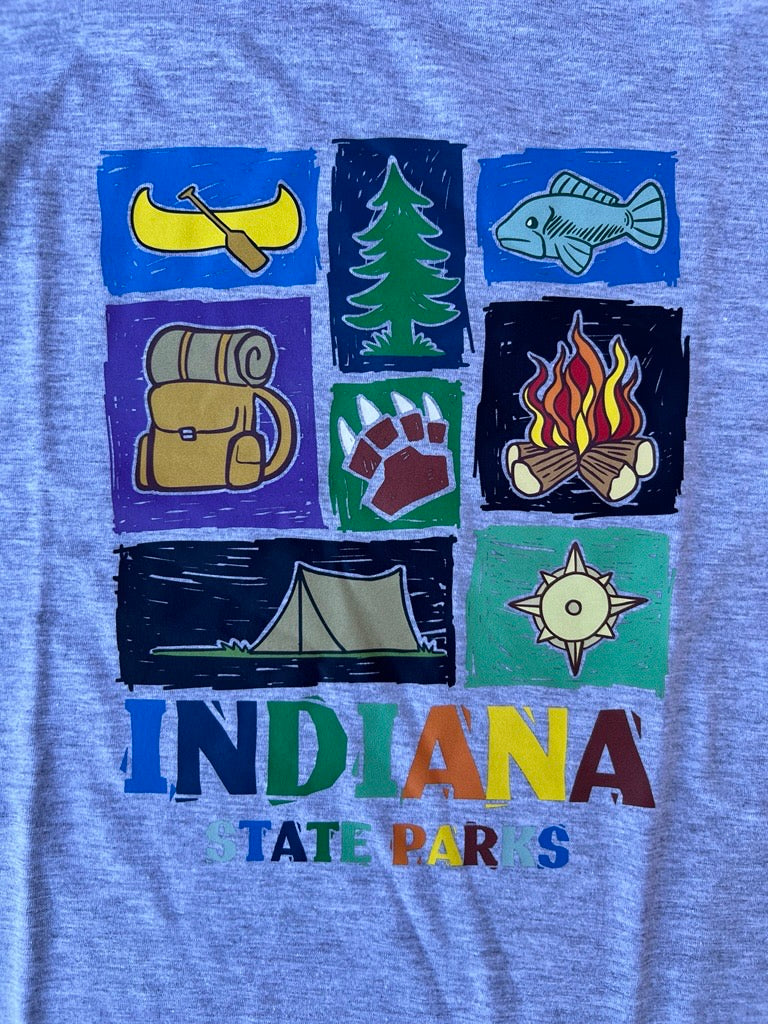 A close-up of a gray youth t-shirt featuring a colorful graphic print of Indiana state-themed camping icons and the text 'INDIANA STATE PARKS'.