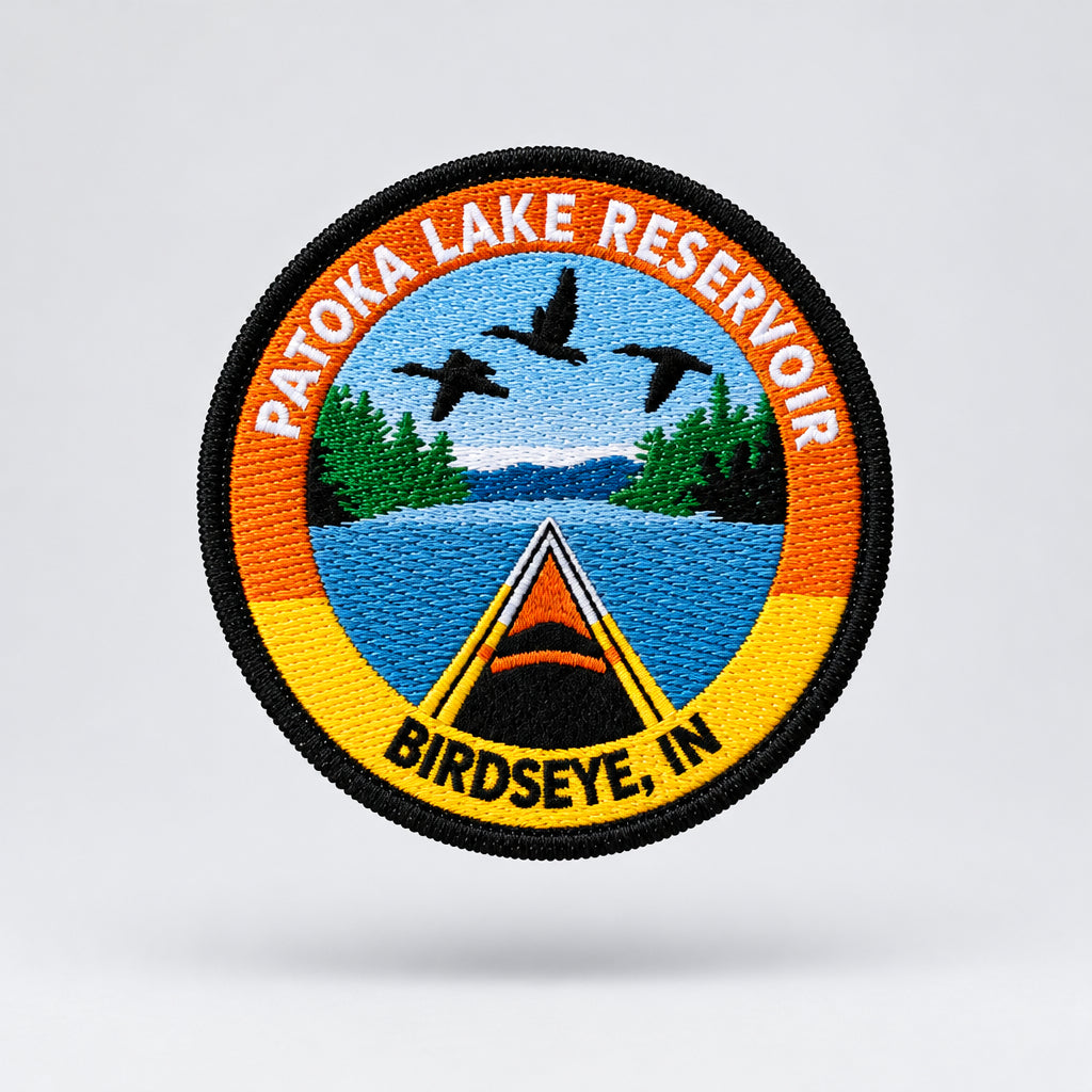 embroidered patch featuring a kayak on a lake with birds flying over head