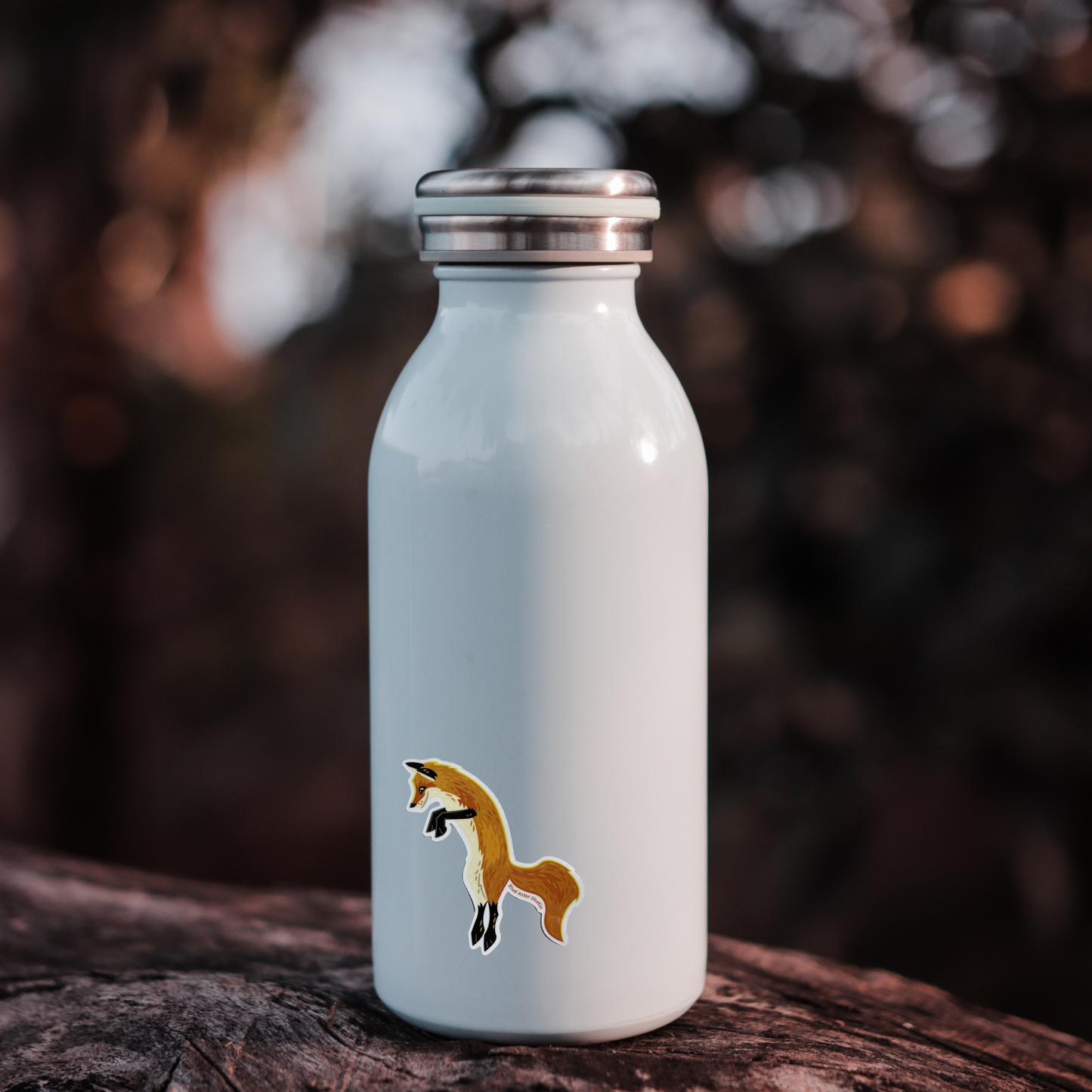 Light blue water bottle with a fox sticker placed on the bottle