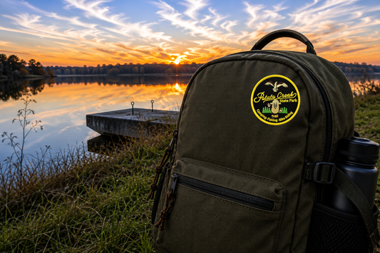 potato creek state park patch on a backpack in front of a lake