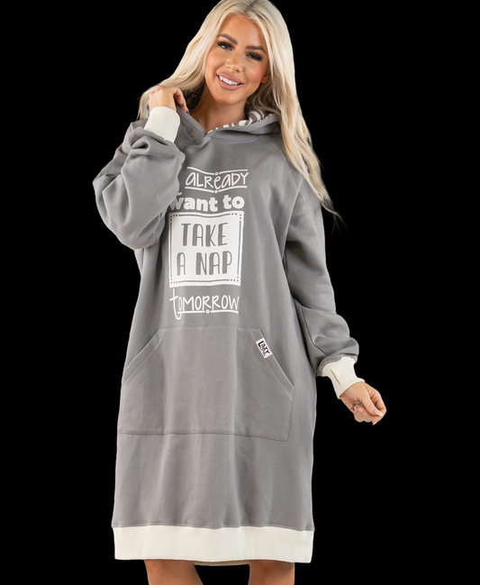 Woman wearing a gray hoodie dress with text on a black background