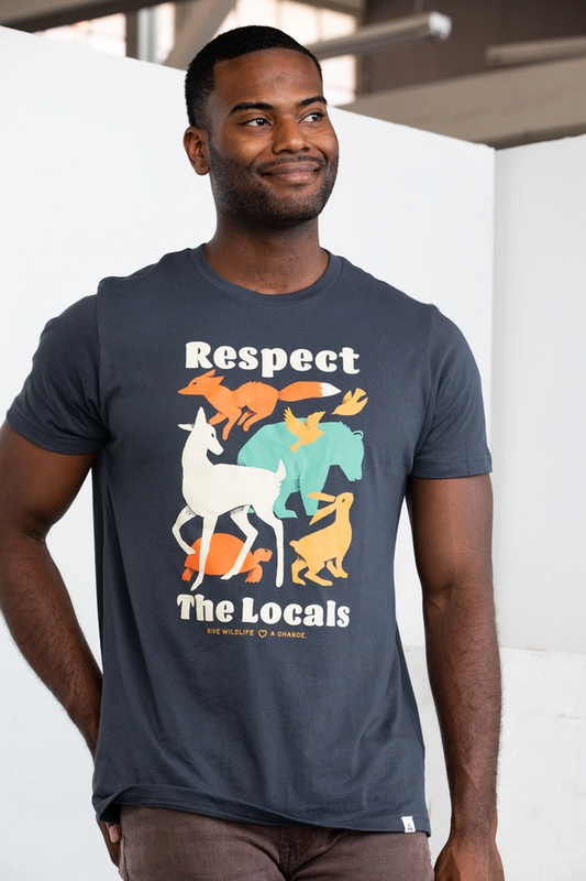 Man wearing a t-shirt with colorful graphic and text 'Respect The Locals' on a plain background