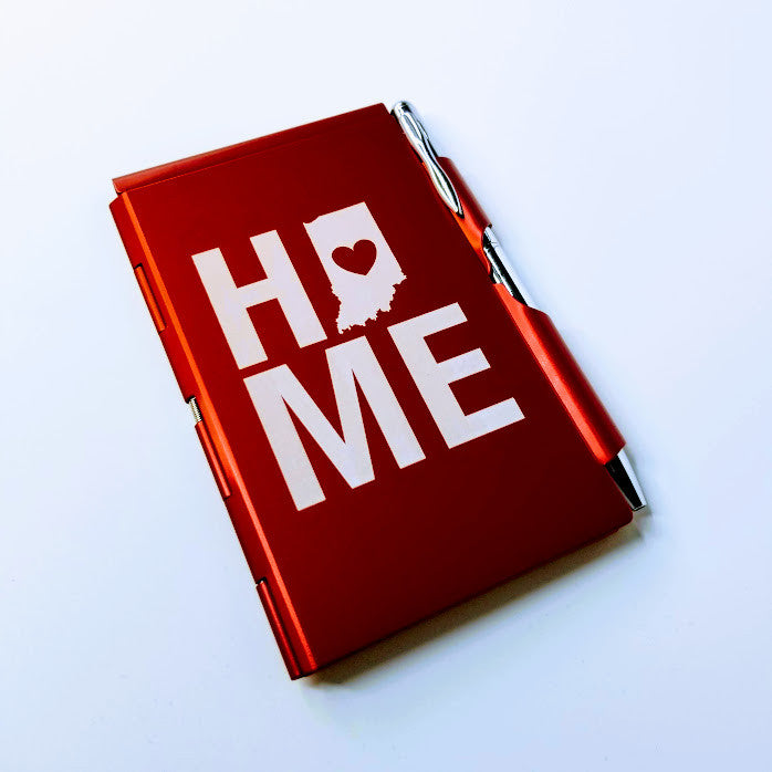 Red notebook with 'HOME' text on a white background
