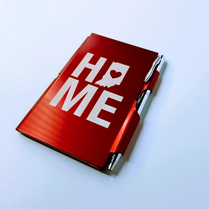 Red notebook with 'HOME' text on a white background