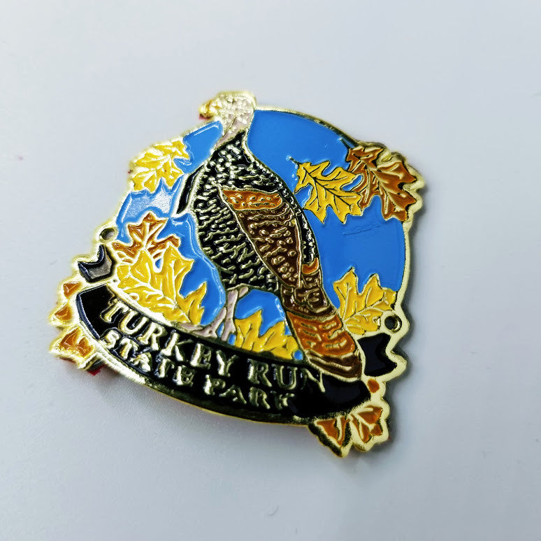 Hiking stick medallion with a turkey design and 'Turkey Run State Park' text with a blue background