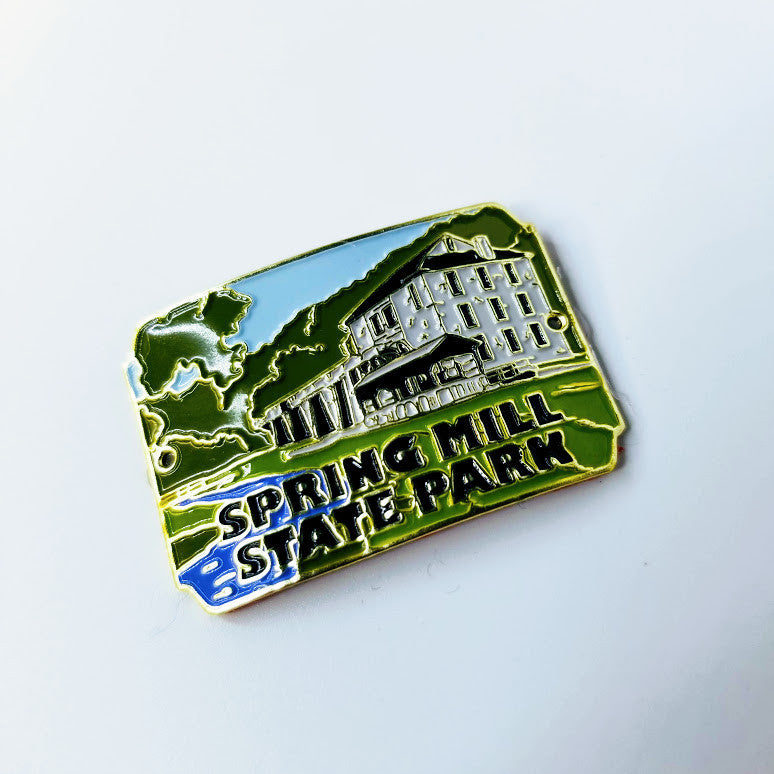 Hiking stick medallion with 'Spring Mill State Park' text and building design on a white background