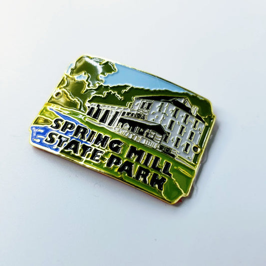 Hiking stick medallion with 'Spring Mill State Park' text and building design on a white background