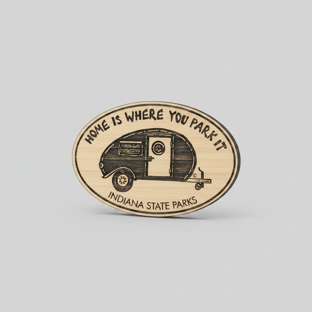 Wooden oval magnet with a camper illustration and 'Home is Where You Park It' text on a wooden surface