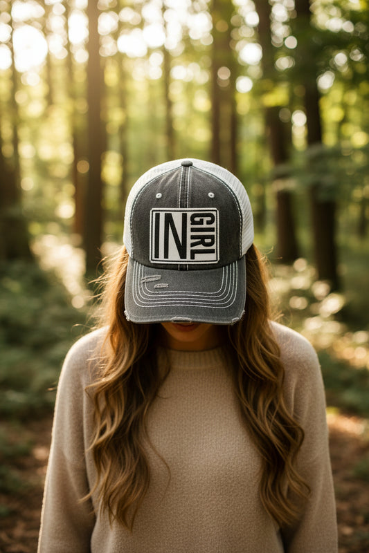 distressed grey hat with white patch on front that reads IN GIRL 