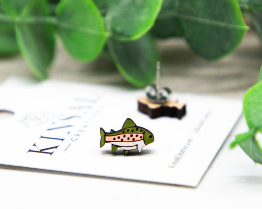 fish earrings on a white card with a beige background