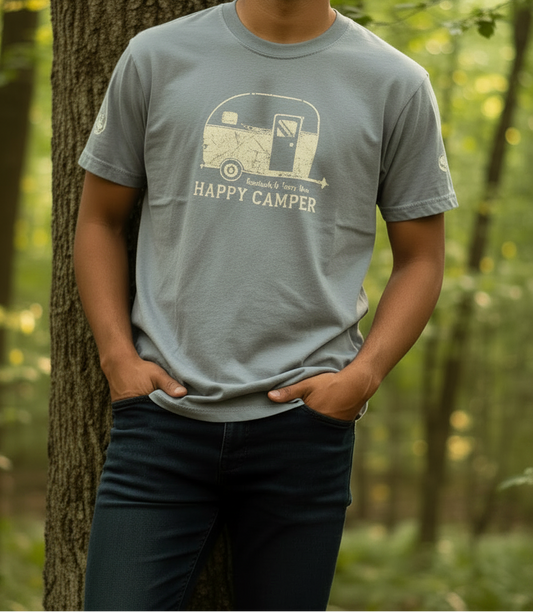 Gray t-shirt with 'Happy Camper' graphic on model in the woods