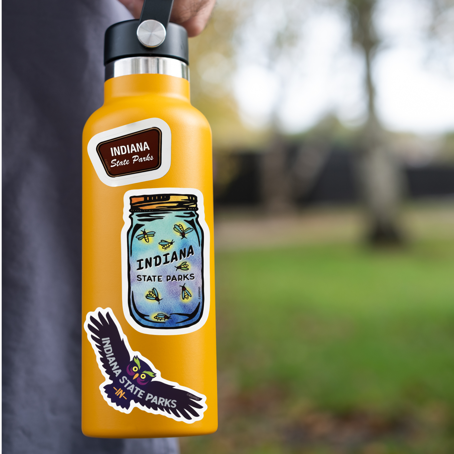 orange water bottle with Indiana State Parks stickers in a park setting