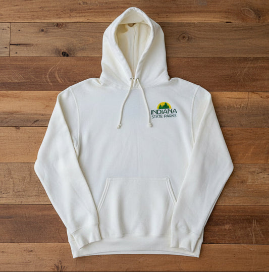An off-white hooded sweatshirt with a drawstring hood and kangaroo pocket, laid flat on a wooden surface. The left chest features a small logo for 'Indiana State Parks' in green, yellow, and black.