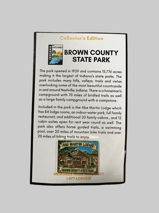 A rectangular printed informational plaque for Brown County State Park, titled 'Collector's Edition,'. The plaque has a white background with black text, orange heading text, a small park logo at top left, and a small vintage-style lodge illustration at the bottom.