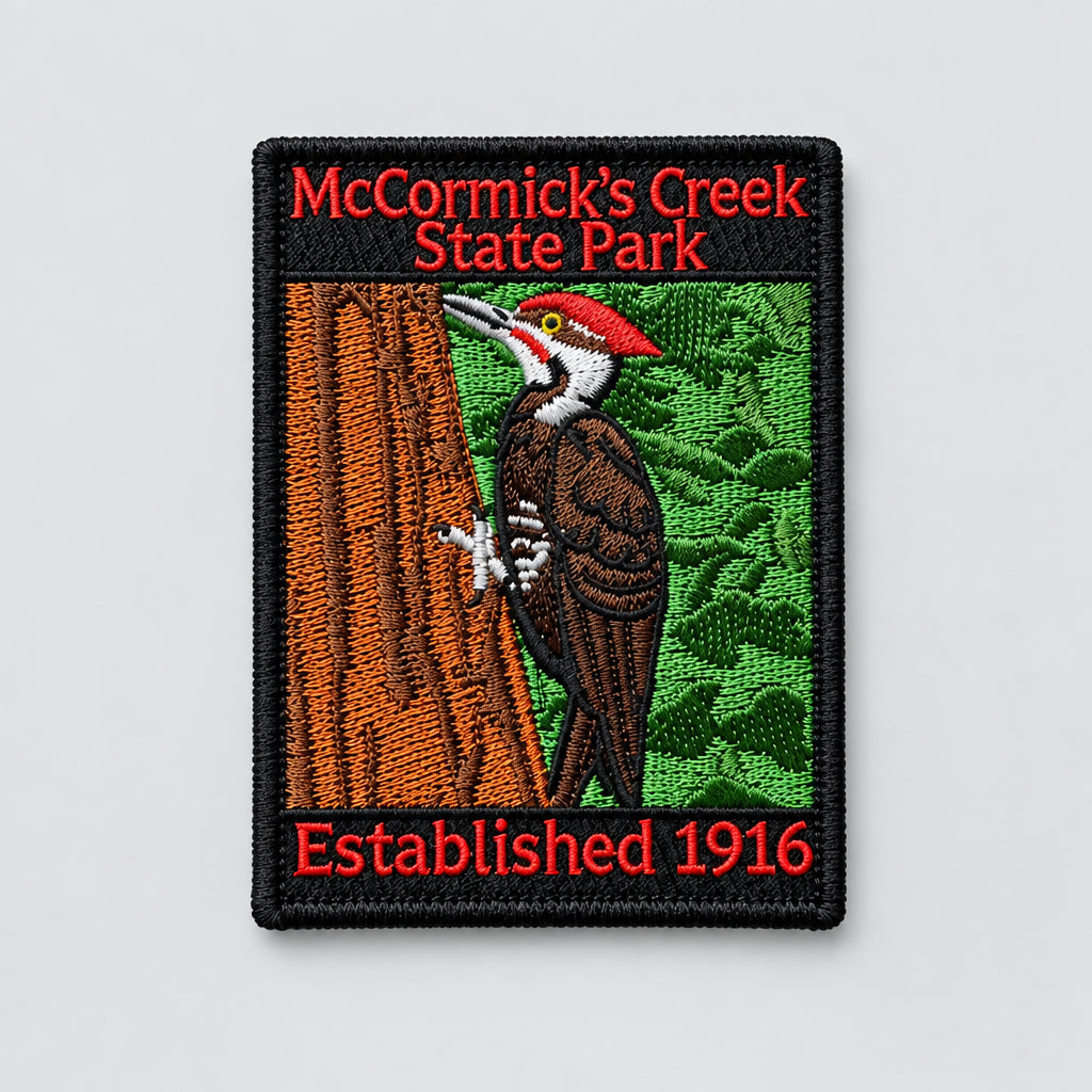 embroidered patch for mccormicks creek state park featuring a wood pecker in a tree