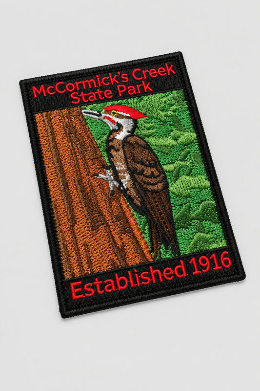 embroidered patch for mccormicks creek state park featuring a wood pecker in a tree