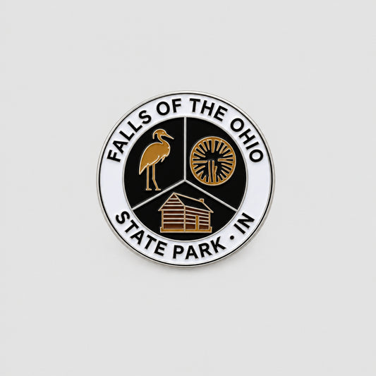 magnet that says falls of the ohio state park and has an image of a heron, fossil, and cabin