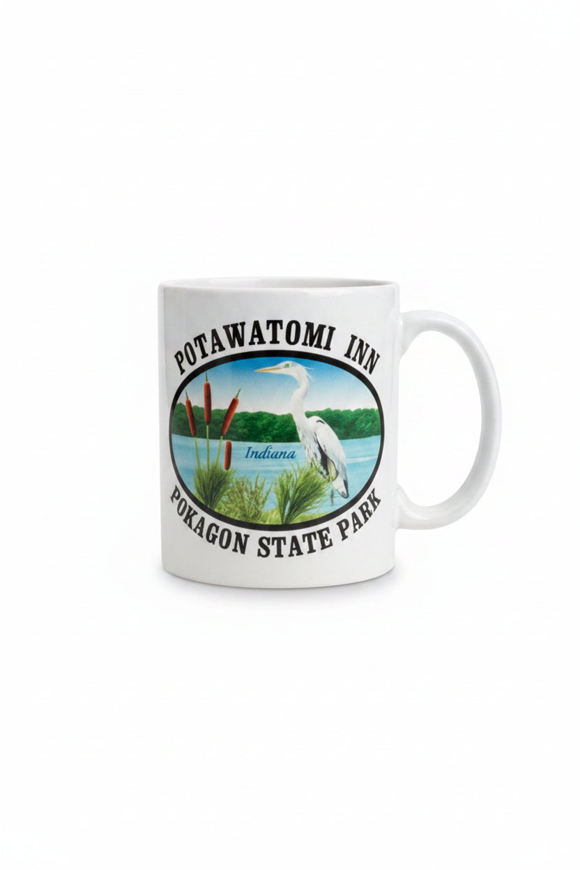 White mug with Potawatomi Inn Pokagon State Park text and image of blue heron