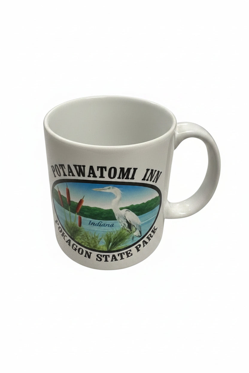 White mug with Potawatomi Inn Pokagon State Park text and image of blue heron
