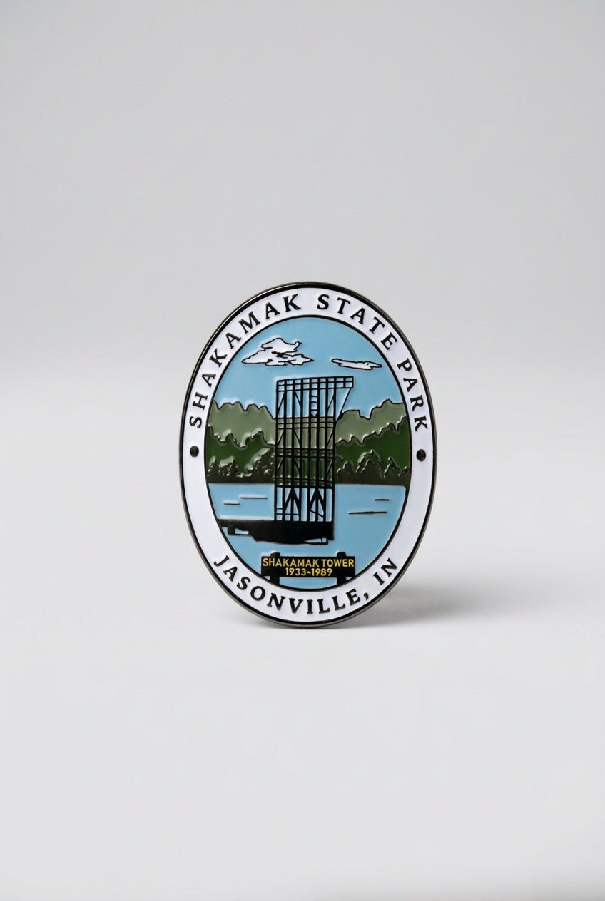 Oval hiking medallion showing the Shakamak Tower with trees and sky in the background, labeled “Shakamak State Park Jasonville, IN.”