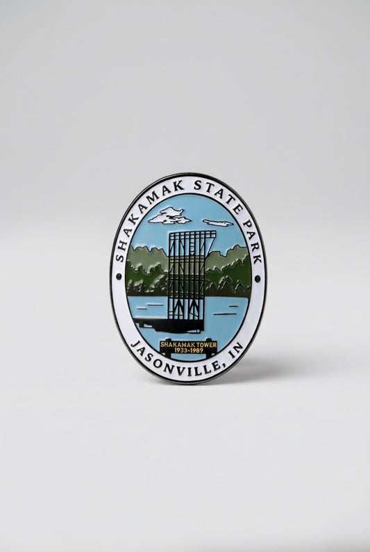 Oval hiking medallion showing the Shakamak Tower with trees and sky in the background, labeled “Shakamak State Park Jasonville, IN.”