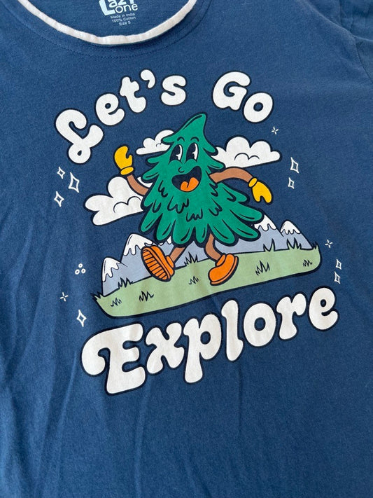 A close-up of a heathered blue t-shirt featuring a colorful graphic of a cartoon pine tree character with the text 'Let's Go Explore' in white.