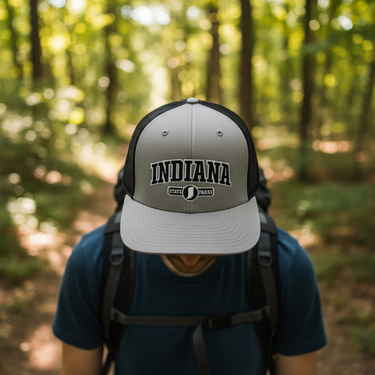 Gray and black cap with 'Indiana State Parks' text on a person hiking