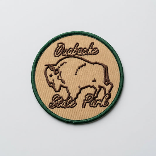 Round embroidered patch with a bison outline and the text “Ouabache State Park” on a tan background with a green border.