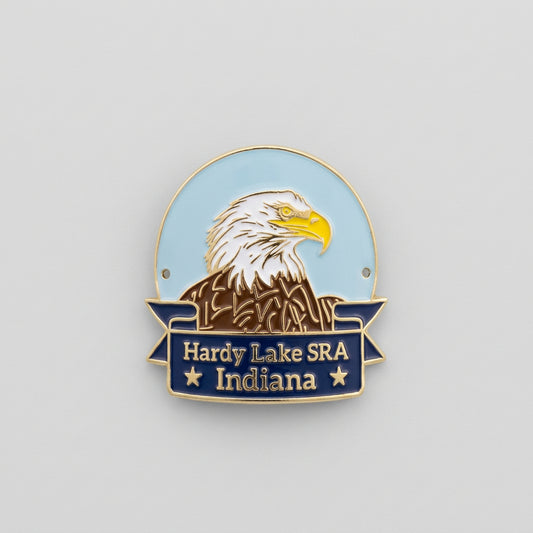 Enamel‑style hiking medallion with an eagle head illustration above a navy banner reading “Hardy Lake SRA Indiana.”