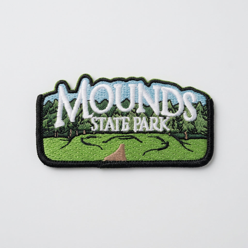 Embroidered patch showing green mounds, a path, and trees with large text reading “Mounds State Park.”