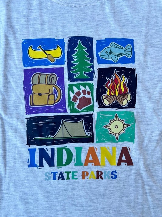 A close-up of a cream youth t-shirt featuring a colorful graphic print of Indiana state-themed camping icons and the text 'INDIANA STATE PARKS'.