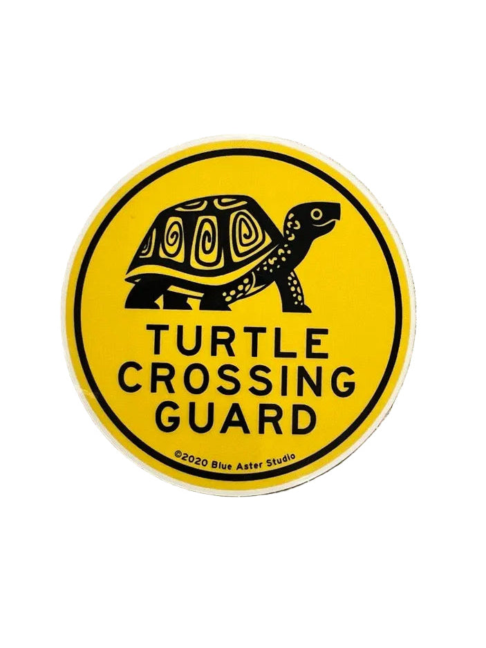 Sticker with turtle design and 'Turtle Crossing Guard' text on a metallic surface