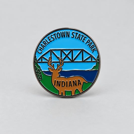 Charlestown State Park hiking stick medallion with an image of a deer and a bridge in the background.