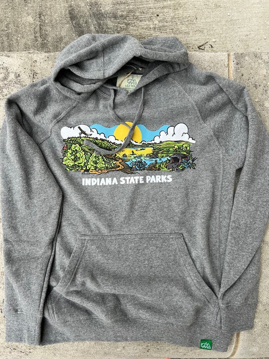 A heather gray pullover hoodie laid flat on a concrete surface, featuring a colorful graphic of Indiana State Parks with a river, mountains, trees, and the text 'INDIANA STATE PARKS' across the chest.