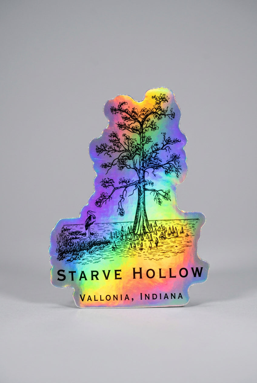 Holographic sticker shaped around an illustrated lakeside tree with surrounding water and vegetation, featuring the text “Starve Hollow” and “Vallonia, Indiana.”