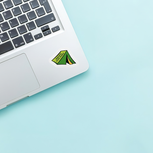 Laptop with a green tent sticker on a light blue background