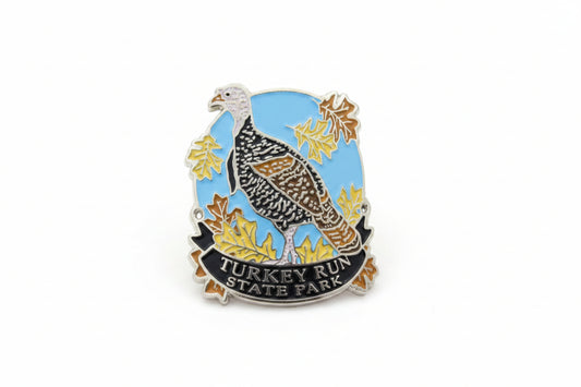 Hiking stick medallion with a turkey design and 'Turkey Run State Park' text on a blue background