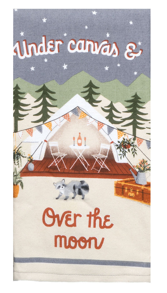 Decorative towel with camping scene and a raccoon with text 'Under canvas & Over the moon' on a blue background.