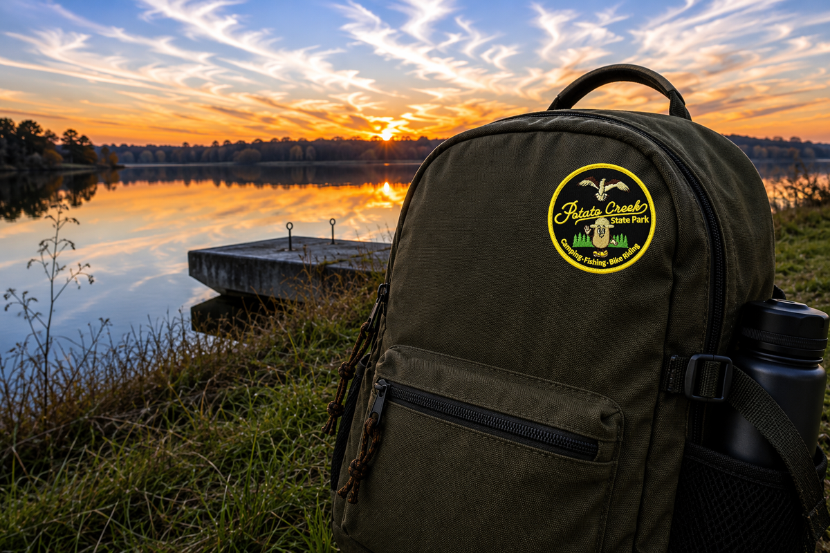 potato creek state park patch on a backpack in front of a lake