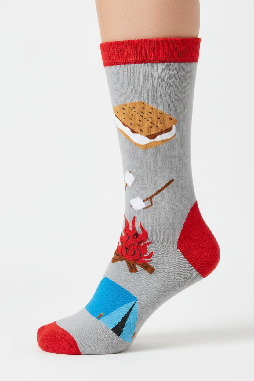 Sock with camping-themed design including a campfire, tent, marshmallow, and graham cracker on a gray background.