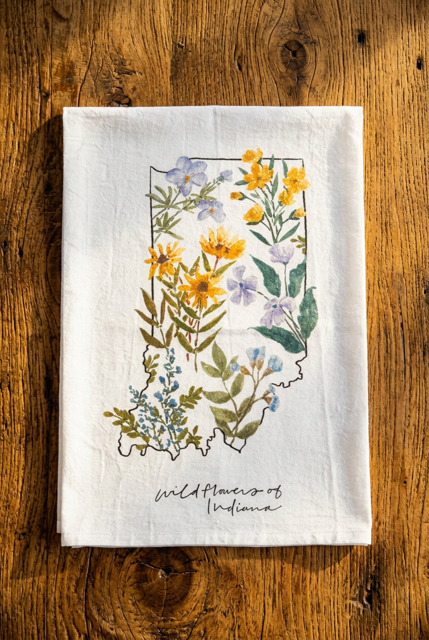 Wildflowers of Indiana tea towel with images of native flowers such as Jacob's ladder, black-eyed Susan, bird's foot violet, wild sweet william, false blue indigo, and sundrops in an Indiana shaped collage
