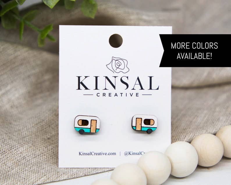 Kinsal Creative earrings on a branded card with decorative beads and plants in the background