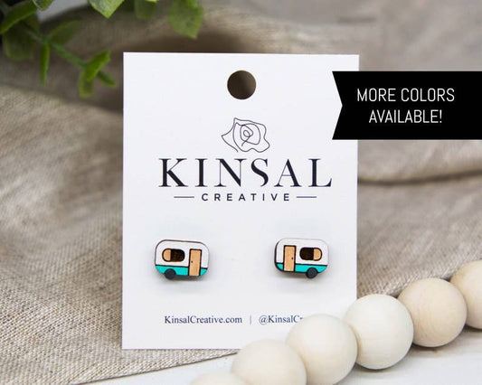 Kinsal Creative earrings on a branded card with decorative beads and plants in the background