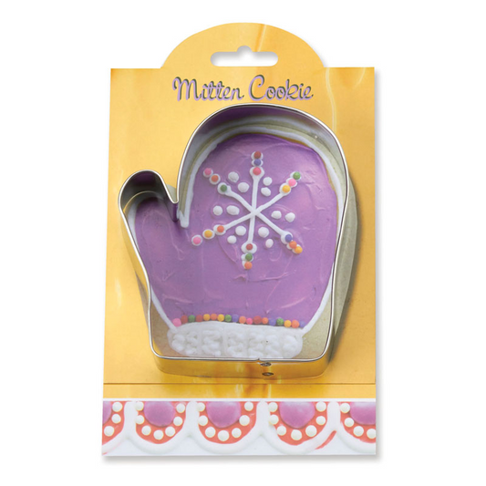 Cookie cutter shaped like a mitten with a snowflake design on a yellow packaging.