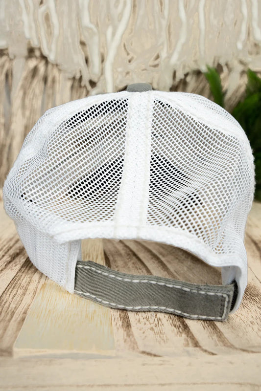 White mesh cap with a gray brim on a wooden surface