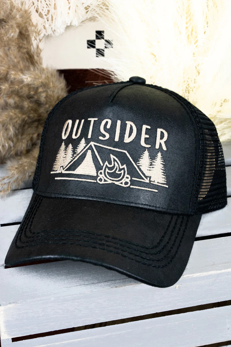 Black trucker hat with 'Outsider' design on a wooden surface